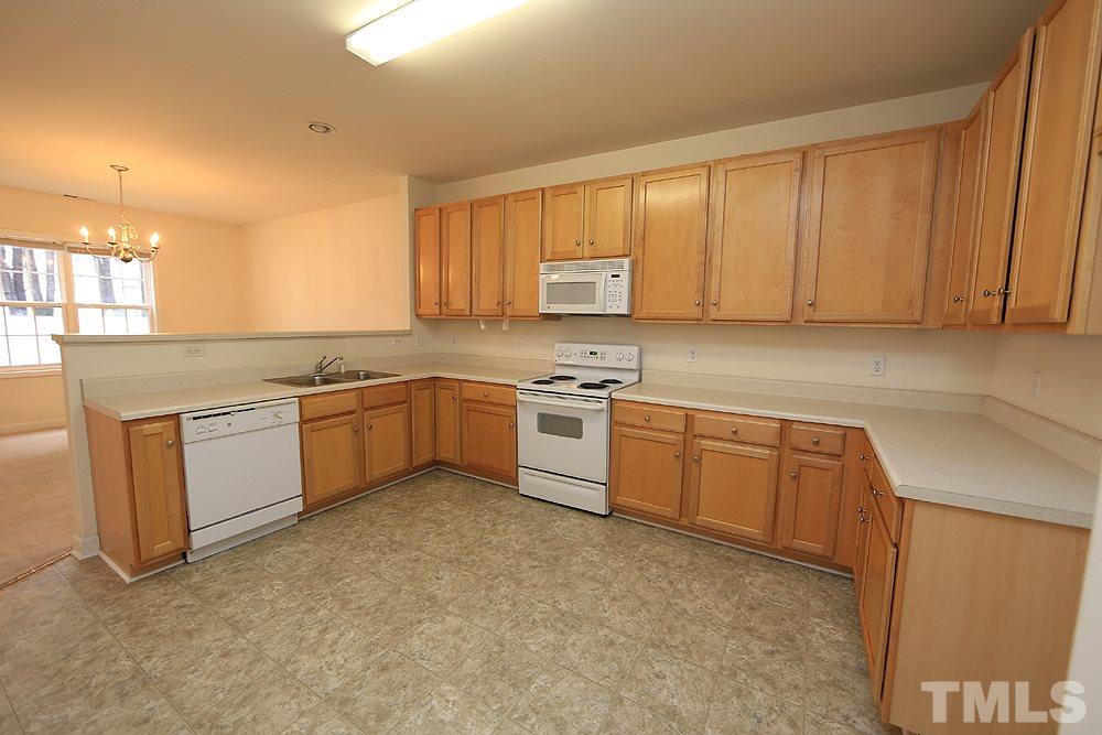 6020 Brambleberry Way Raleigh, NC 27616 - Photo 5 of 14 Large, open kitchen features pantry, laundry closet, (washer and dryer convey). Kitchen door leads to two-car garage.