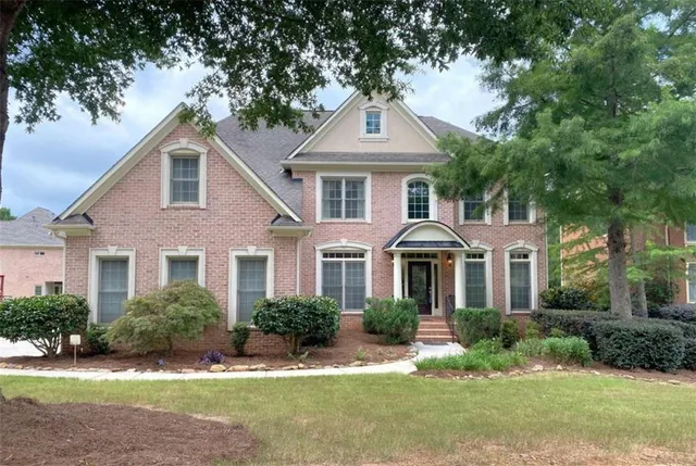 a front view of a house with a yard