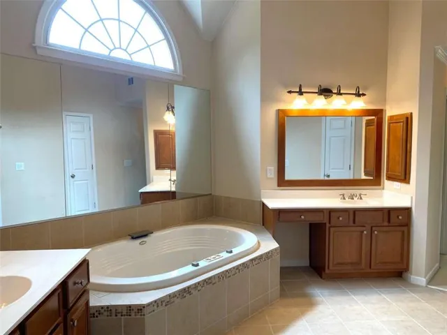 an empty room with a window and doors