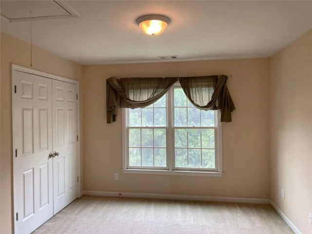 a living room with furniture and floor to ceiling window