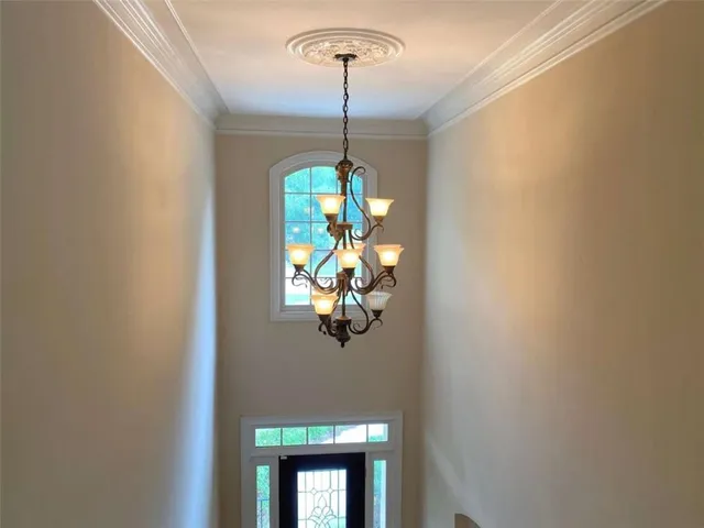 a kitchen with granite countertop a refrigerator and a stove top oven