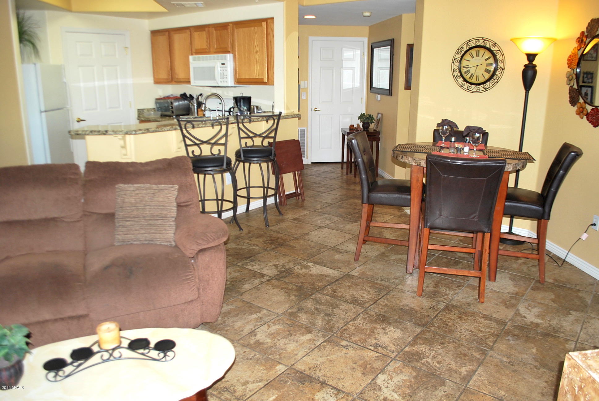 10030 West Indian School Road, Unit 158 Phoenix, AZ 85037 - Photo 13 of 28 a dining room with furniture and wooden floor
