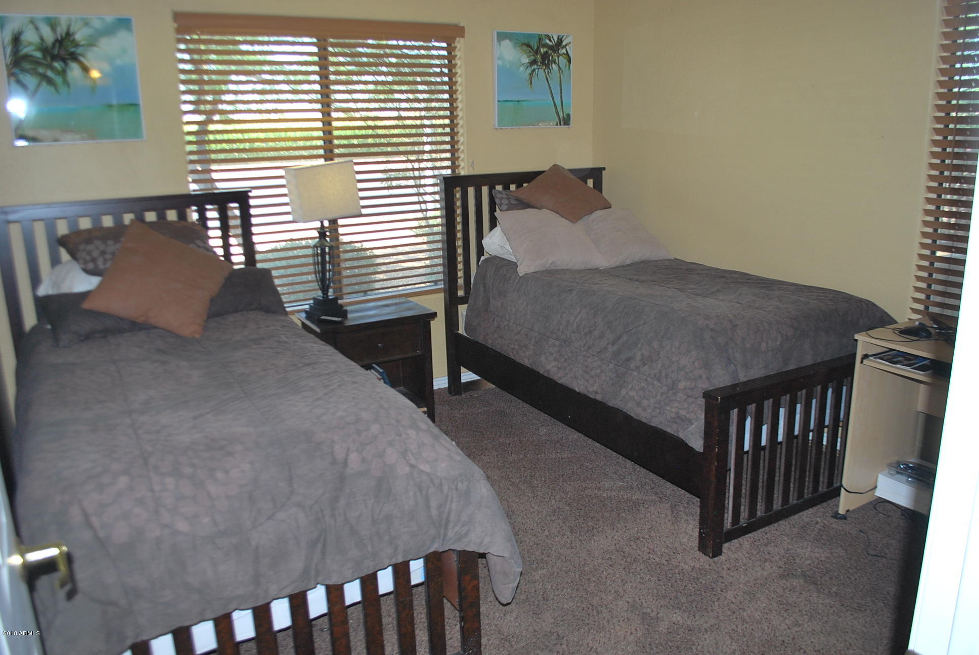 10030 West Indian School Road, Unit 158 Phoenix, AZ 85037 - Photo 20 of 28 a bedroom with a bed and a window