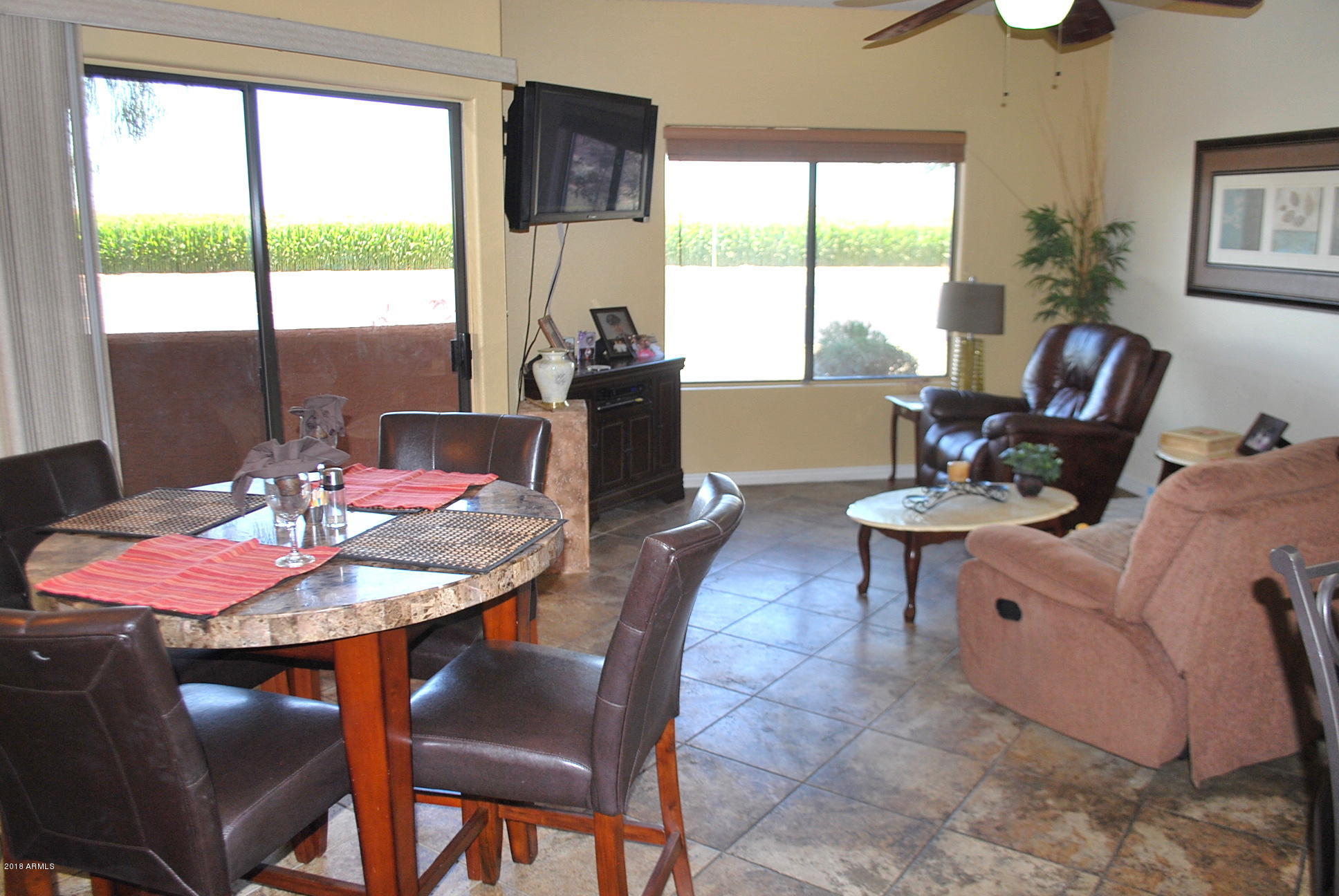 10030 West Indian School Road, Unit 158 Phoenix, AZ 85037 - Photo 2 of 28 a view of a dining room with furniture window and outside view
