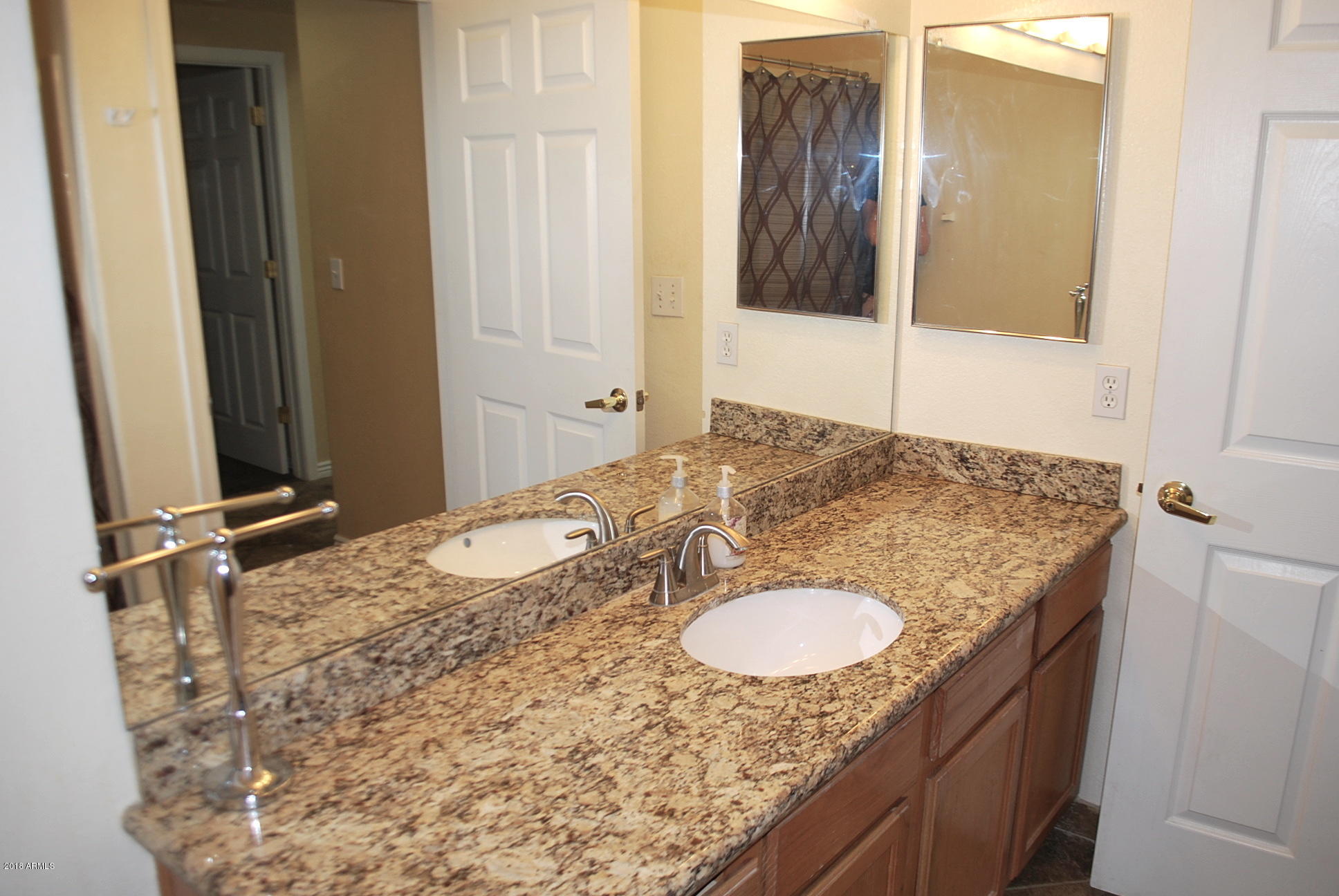 10030 West Indian School Road, Unit 158 Phoenix, AZ 85037 - Photo 21 of 28 a bathroom with a granite countertop sink and a mirror