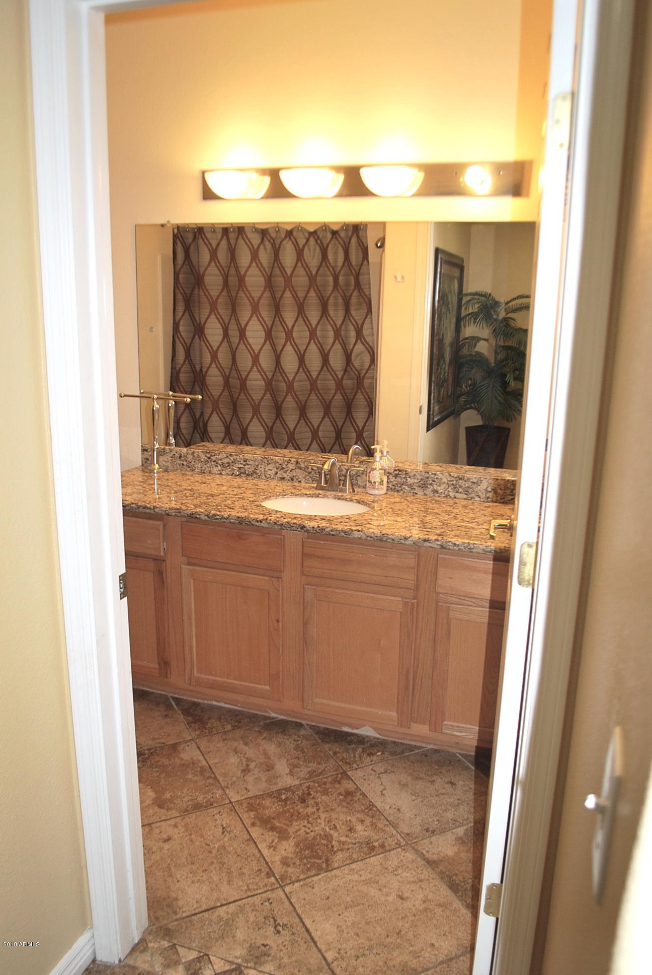 10030 West Indian School Road, Unit 158 Phoenix, AZ 85037 - Photo 22 of 28 a bathroom with a sink and a mirror