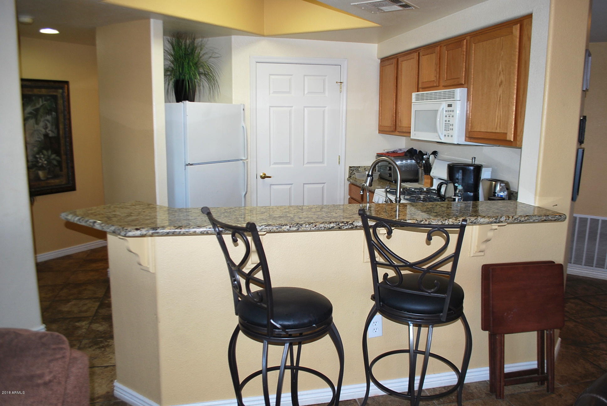 10030 West Indian School Road, Unit 158 Phoenix, AZ 85037 - Photo 5 of 28 a view of a dining room with furniture and a chandelier