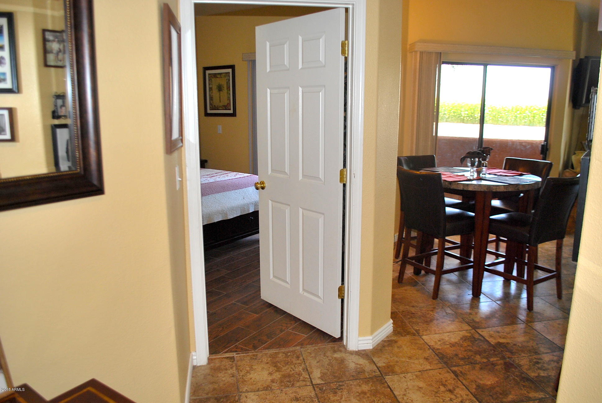 10030 West Indian School Road, Unit 158 Phoenix, AZ 85037 - Photo 9 of 28 a view of a livingroom from a hallway