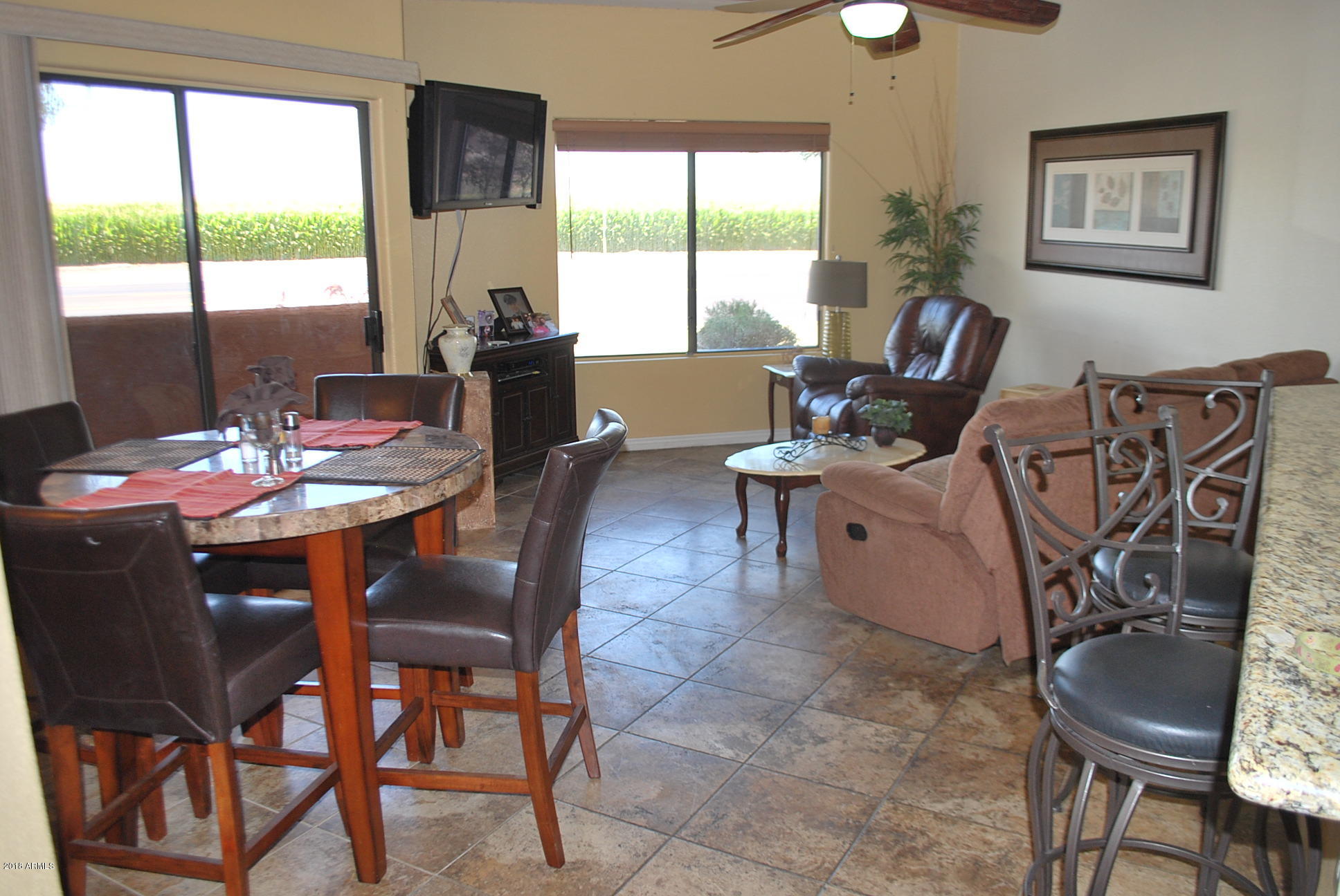 10030 West Indian School Road, Unit 158 Phoenix, AZ 85037 - Photo 10 of 28 a view of a dining room with furniture window and outside view