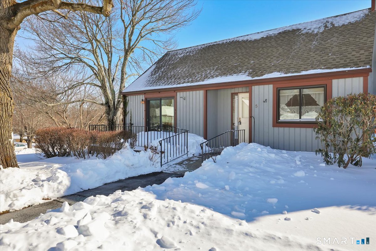a view of a house with a yard covered in snow