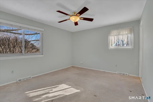a view of room with window and ceiling fan