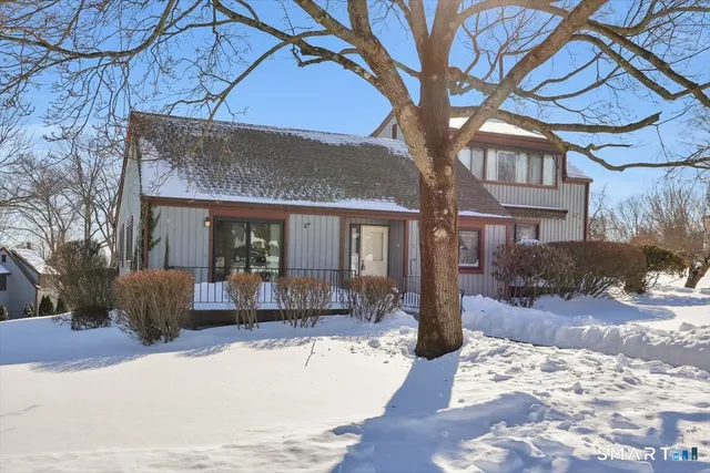 a view of a house with a yard covered in snow