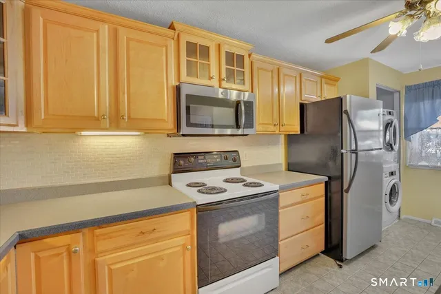 a kitchen with stainless steel appliances granite countertop a refrigerator stove and sink