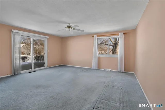 an empty room with windows and closet