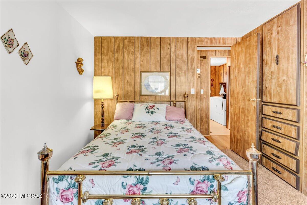 5840 West Flying W Street Tucson, AZ 85713 - Photo 23 of 38 a view of a bedroom with wooden floor and bed