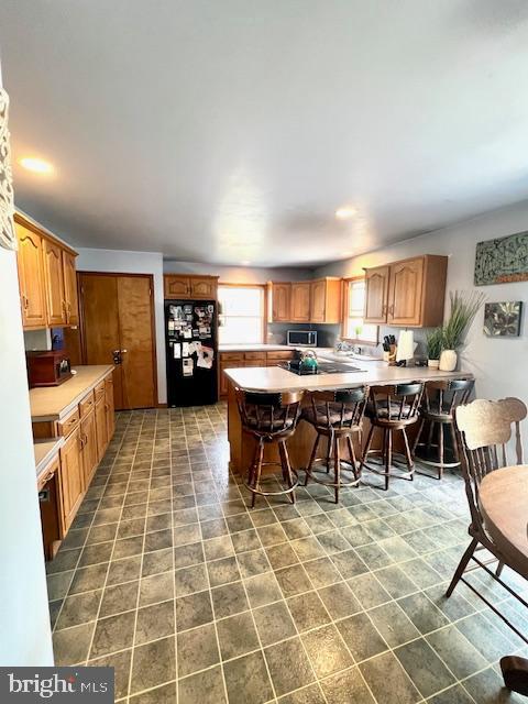328 Red Pump Road Nottingham, PA 19362 - Photo 10 of 37 a large dining hall with stainless steel appliances granite countertop a stove a sink a dining table and chairs