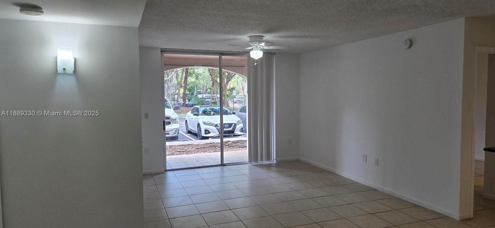 2173 Renaissance Boulevard, Unit 103 Miramar, FL 33025 - Photo 11 of 36 a very nice looking room with a glass door and furniture