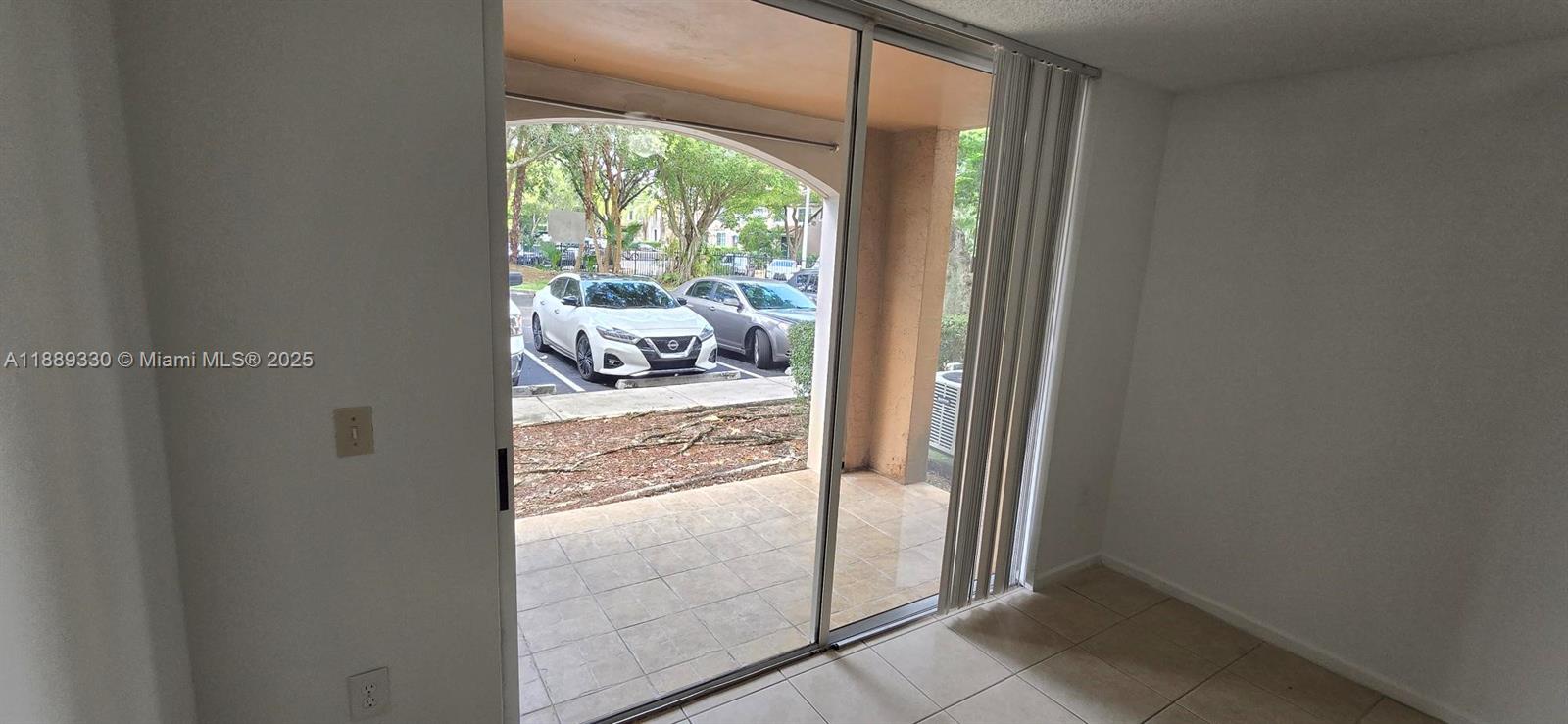 2173 Renaissance Boulevard, Unit 103 Miramar, FL 33025 - Photo 13 of 36 a view of a balcony and a floor to ceiling window