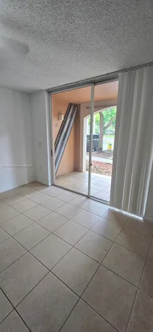 a kitchen with granite countertop a sink and a stove top oven