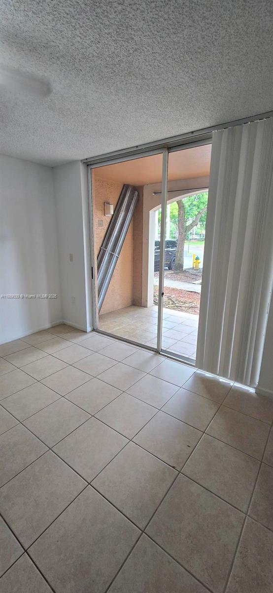 2173 Renaissance Boulevard, Unit 103 Miramar, FL 33025 - Photo 14 of 36 a view of an empty room with a fireplace and a large window