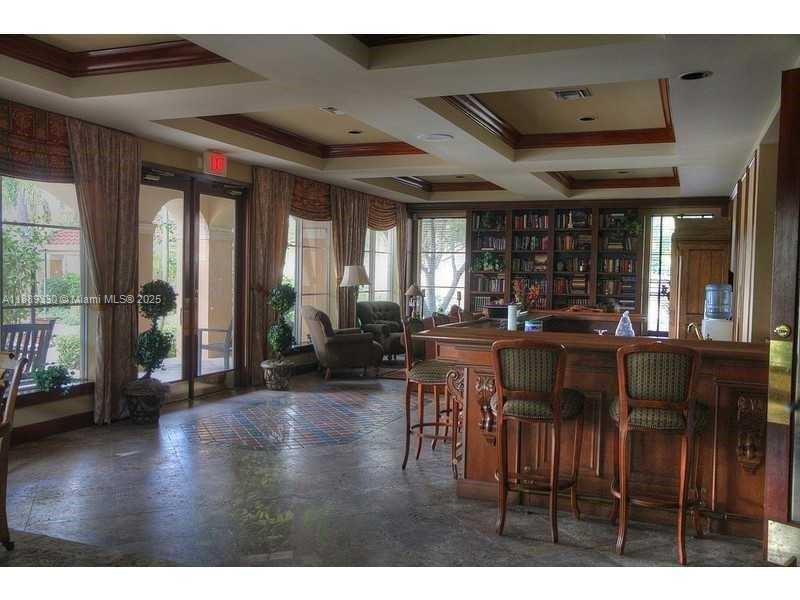 2173 Renaissance Boulevard, Unit 103 Miramar, FL 33025 - Photo 35 of 36 a view of a dining room with furniture window and wooden floor