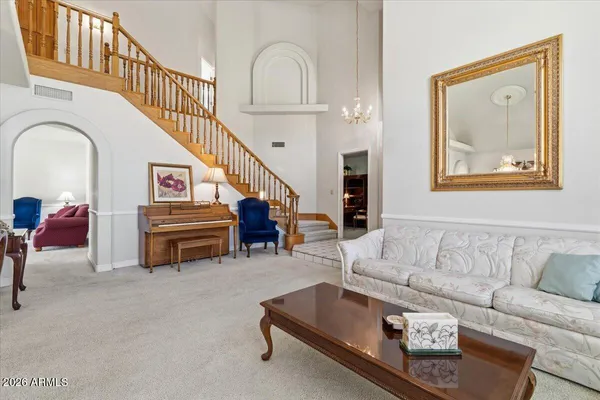 a kitchen with stainless steel appliances granite countertop a sink a stove a refrigerator cabinets and living room view
