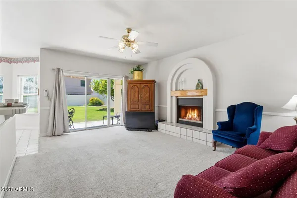 a spacious bathroom with a granite countertop tub a double vanity sink a window and a mirror