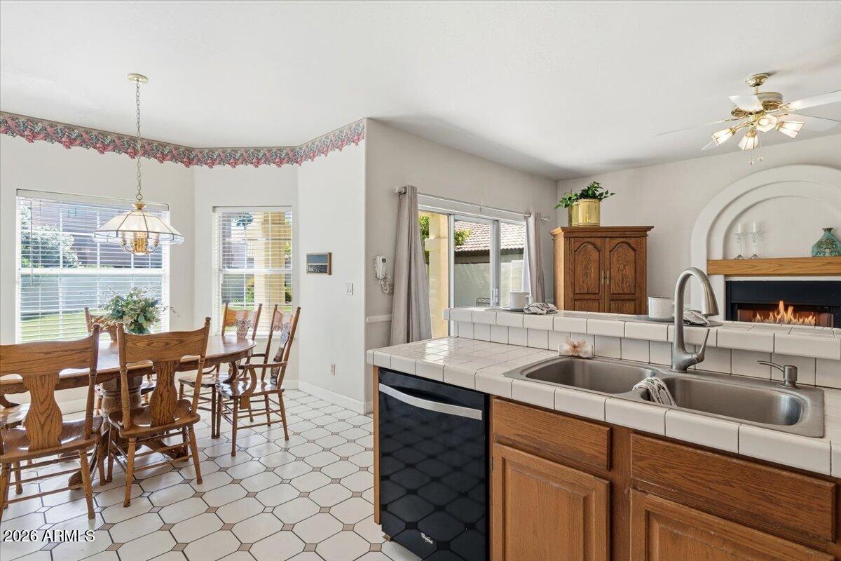 1919 East Clipper Court Gilbert, AZ 85234 - Photo 20 of 62 a kitchen with granite countertop a sink dining table and chairs
