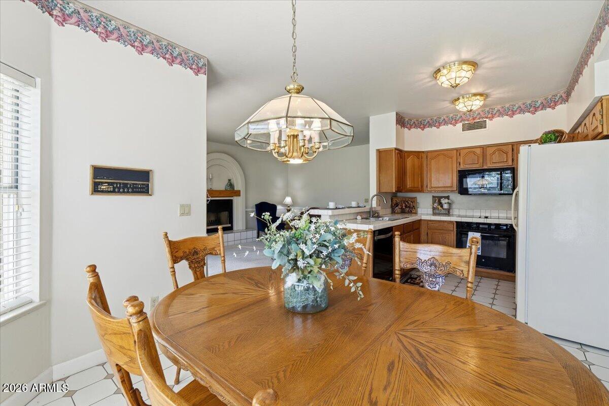1919 East Clipper Court Gilbert, AZ 85234 - Photo 22 of 62 a view of a dining room with furniture and a chandelier