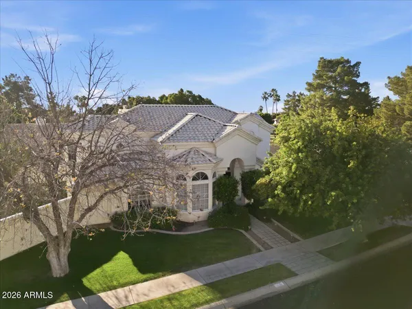 a front view of a house with a garden and yard