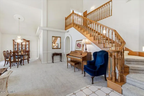a living room with furniture a table and a chandelier