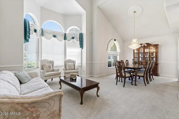 a view of a dining room with furniture and a chandelier