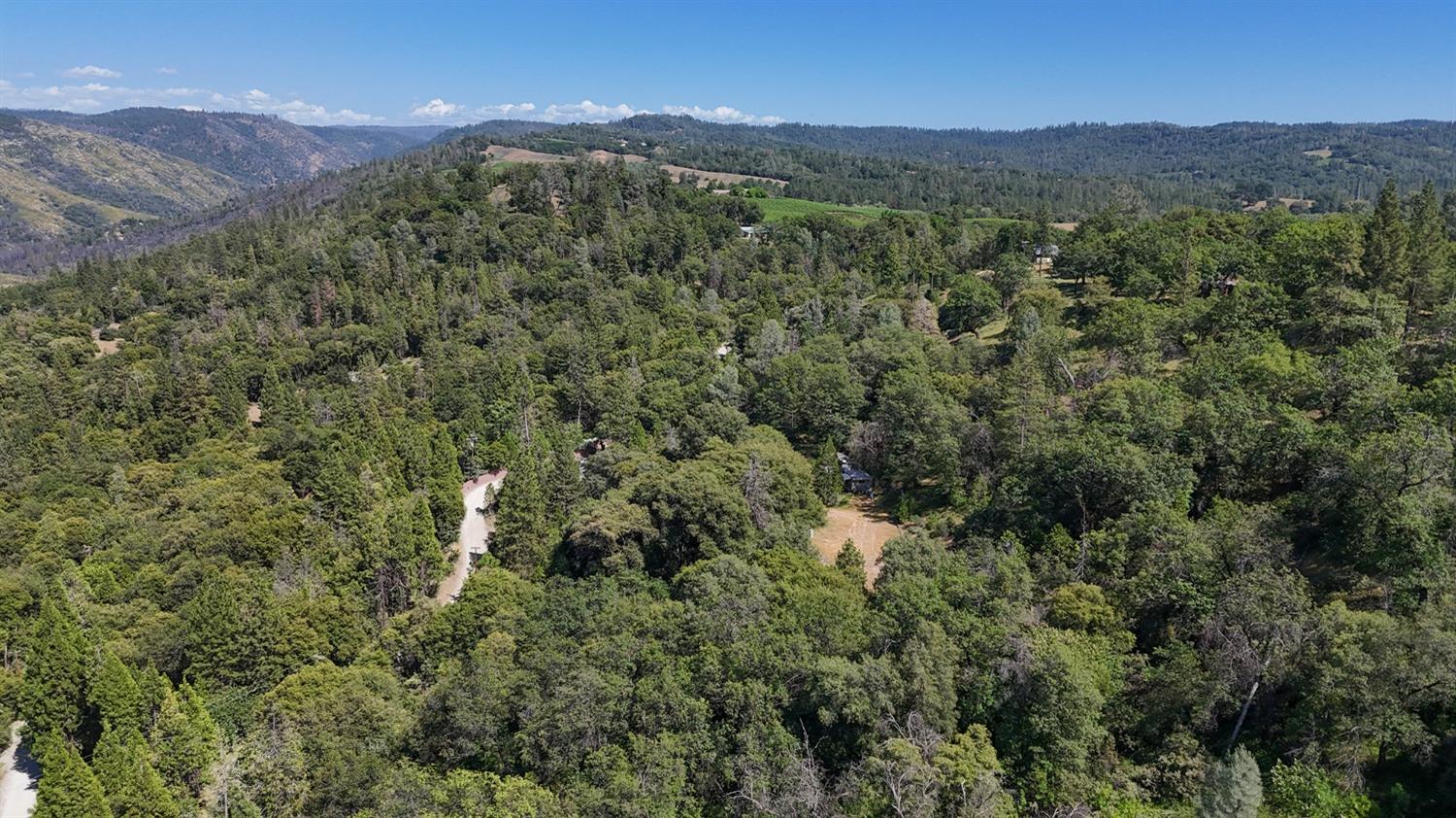 6860 Ant Hill Road Somerset, CA 95684 - Photo 36 of 40 a view of a lush green hillside and a building