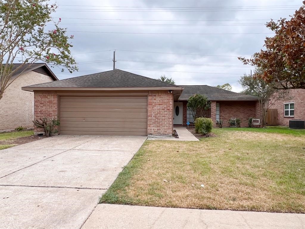 3122 Windmill Street Sugar Land, TX 77479 - Photo 1 of 13 a front view of a house with a yard and garage
