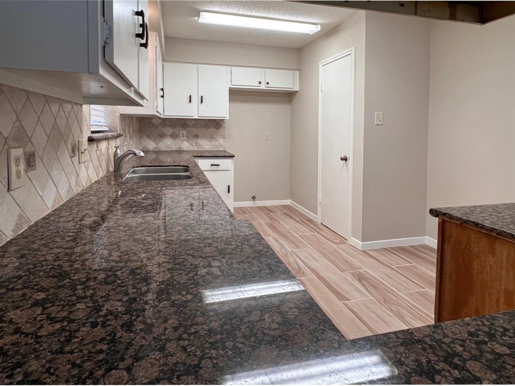 3122 Windmill Street Sugar Land, TX 77479 - Photo 4 of 13 a hallway with wooden floor and cabinets