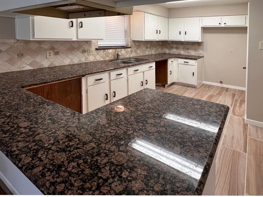3122 Windmill Street Sugar Land, TX 77479 - Photo 5 of 13 a kitchen with a sink stove and cabinets