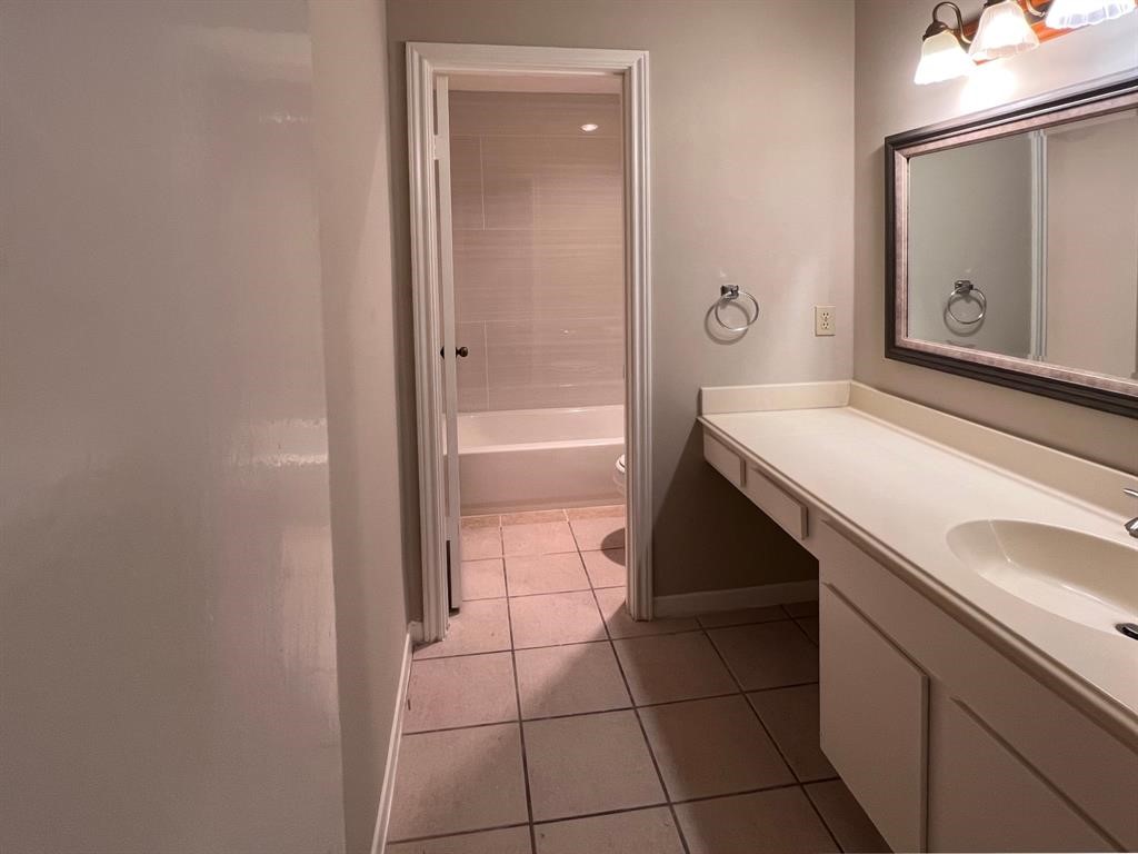 3122 Windmill Street Sugar Land, TX 77479 - Photo 6 of 13 a bathroom with a granite countertop sink a toilet and vanity