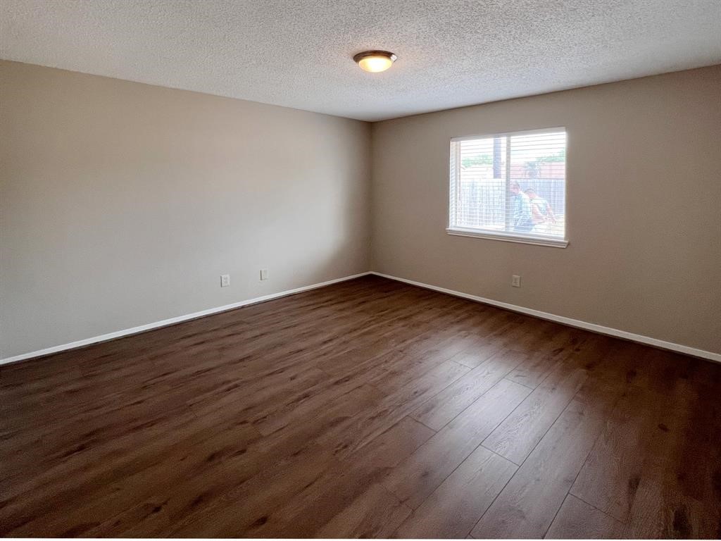 3122 Windmill Street Sugar Land, TX 77479 - Photo 7 of 13 a view of an empty room with wooden floor and a window
