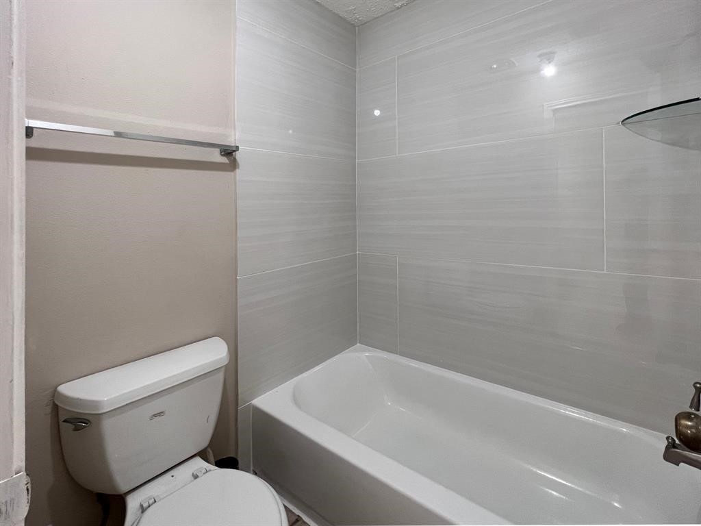 3122 Windmill Street Sugar Land, TX 77479 - Photo 9 of 13 a white toilet sitting next to a bath tub
