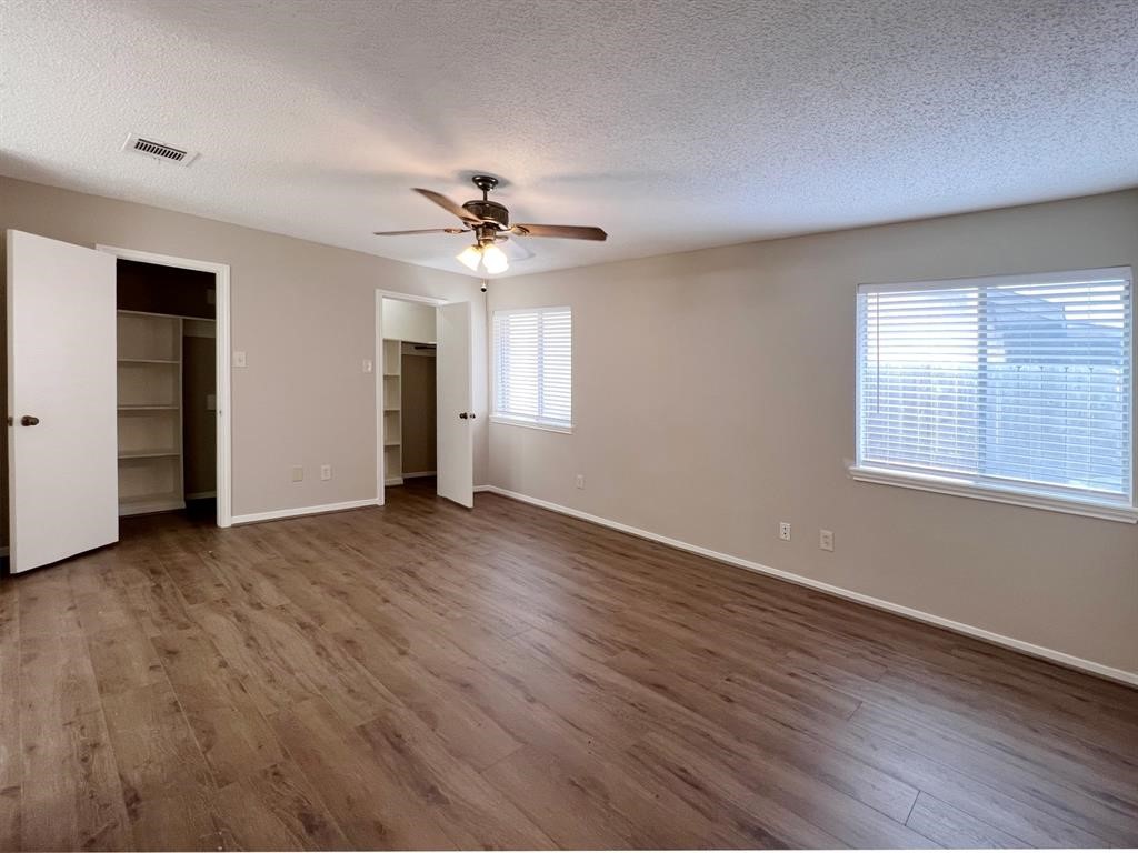 3122 Windmill Street Sugar Land, TX 77479 - Photo 10 of 13 an empty room with wooden floor and windows