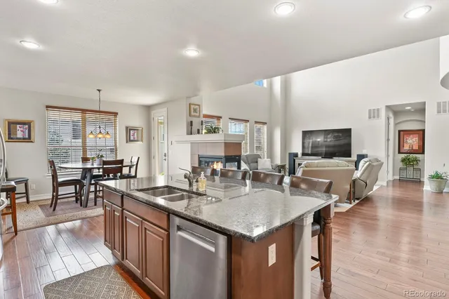 a kitchen with granite countertop a table chairs stove and kitchen view