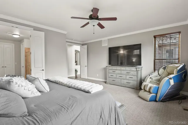 a bedroom with bed and a flat screen tv