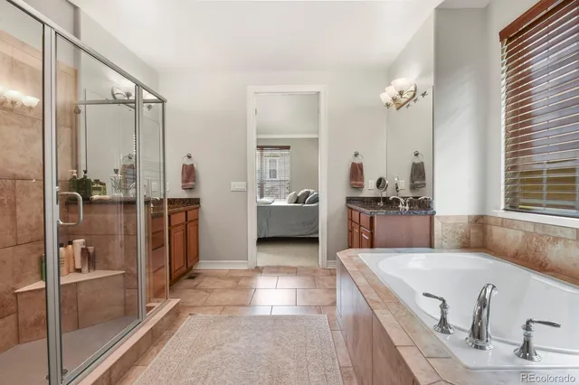 a living room with stainless steel appliances furniture and a kitchen view