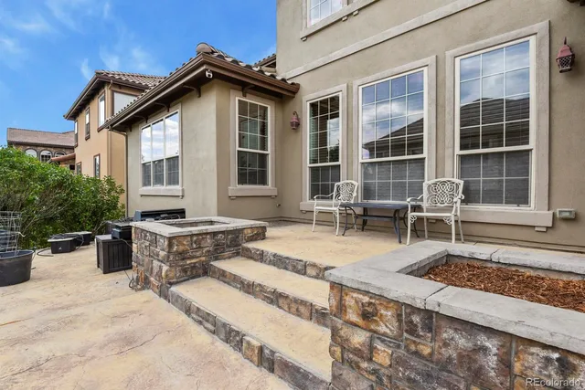 a front view of a house with outdoor seating