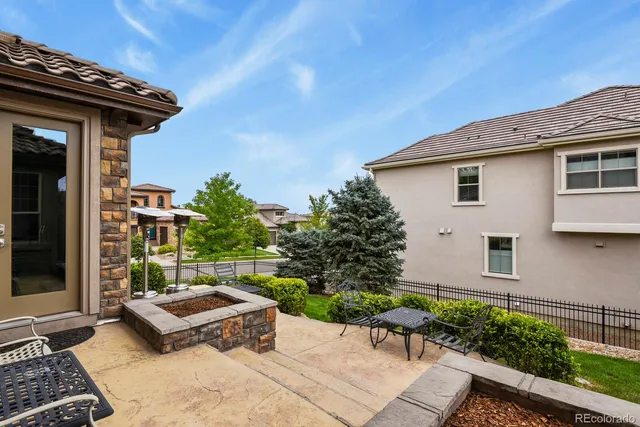 an aerial view of a house with a garden and lake view