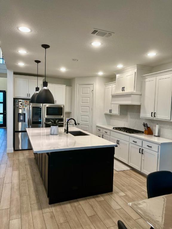 1113 Scenic Grn Loop Georgetown, TX 78628 - Photo 11 of 38 a kitchen with kitchen island stainless steel appliances a sink stove and cabinets