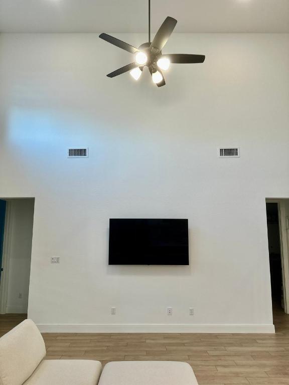 1113 Scenic Grn Loop Georgetown, TX 78628 - Photo 13 of 38 a living room with furniture and a flat screen tv