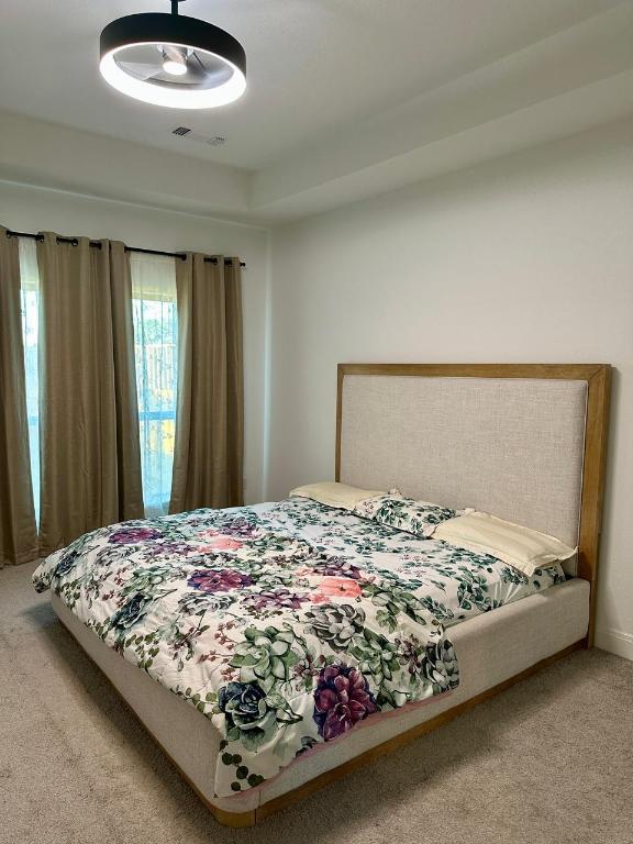 1113 Scenic Grn Loop Georgetown, TX 78628 - Photo 16 of 38 a bed sitting in a bedroom next to a window and cabinet