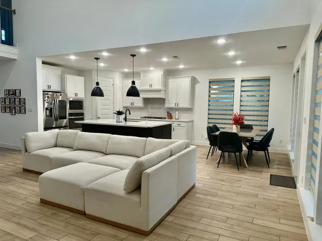 a living room with furniture and a wooden floor
