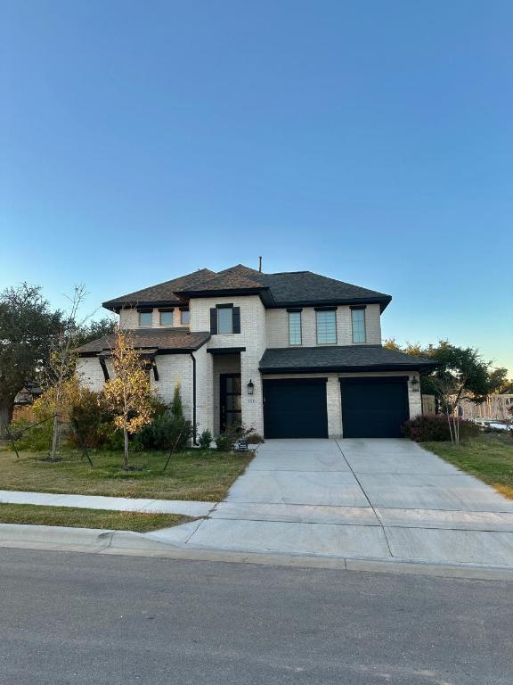 1113 Scenic Grn Loop Georgetown, TX 78628 - Photo 5 of 38 a front view of a house with a garden